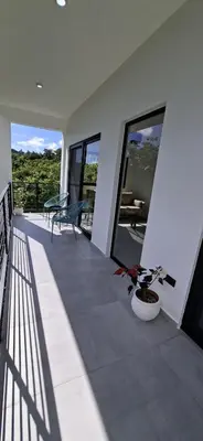 a balcony of a house with a bench and windows at SunSeaBeach Villa Iguana - 3 SZ - Strandnähe in Las Galeras