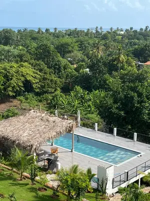 a resort swimming pool with a thatched roof at SunSeaBeach Villa Iguana - 3 SZ - Strandnähe in Las Galeras