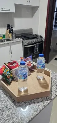 two bottles of water on a cutting board on a kitchen counter at Rob's Place in Mendoza