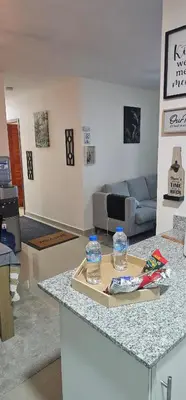 two bottles of water on a counter in a living room at Rob's Place in Mendoza