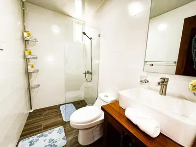 a white bathroom with a sink and a toilet at Serene Penthouse near Homs Hospital in El Ejido