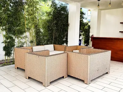 two wicker chairs and a table on a patio at Serene Penthouse near Homs Hospital in El Ejido