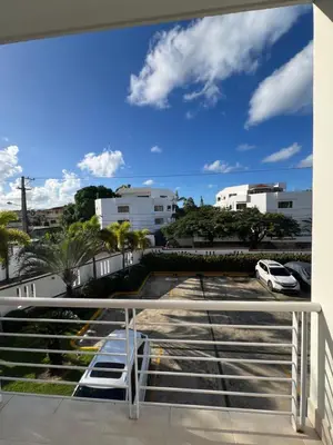 a balcony with a car parked in a parking lot at Caribbean luxury in Sosúa