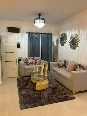 a living room with two couches and a glass table at Byk 2 in Nagua