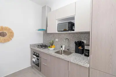 a kitchen with a sink and a microwave at Elegant Coastal Escape Spacious 2BR Bayahibe in San Rafael del Yuma