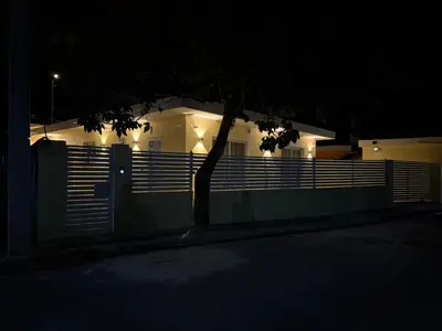 a house with a fence and a tree in front of it at Paradiso Italia Miches in Miches