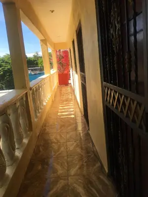 a hallway of a house with a red door at Hotel Pensión la Hermosa Barahona in Santa Cruz de Barahona