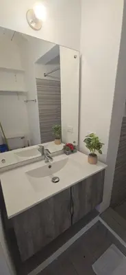 a bathroom with a sink and a mirror at El Pelicano Apart-Hotel in Las Galeras