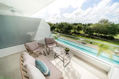 a balcony with a view of a swimming pool at Vista Velero – 1BR Coastal Escape @ Cana Rock Star in Punta Cana