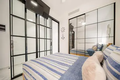 a bedroom with two beds and a large window at Vista Velero – 1BR Coastal Escape @ Cana Rock Star in Punta Cana