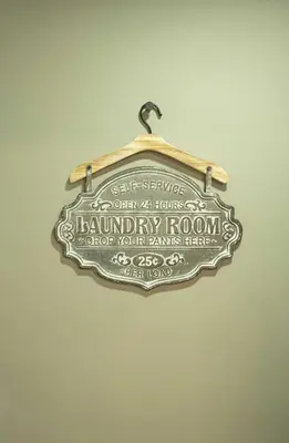 a sign for a laundry room on a wall at The Jade Lodge 2BR Apartment- Enjoy the nature in Puerto Plata