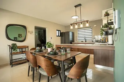 a kitchen and dining room with a table and chairs at The Jade Lodge 2BR Apartment- Enjoy the nature in Puerto Plata