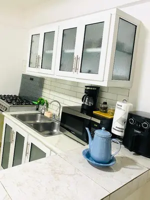 a kitchen with a blue tea kettle on a counter at Apartment with Everything AC Wifi and Solar panel in Bonao