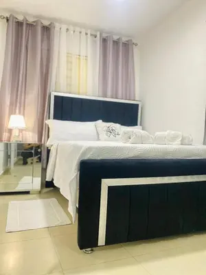 a bedroom with a large bed with a blue headboard at Apartment with Everything AC Wifi and Solar panel in Bonao