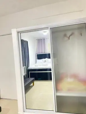a view of a bedroom with a bed through a mirror at Apartment with Everything AC Wifi and Solar panel in Bonao