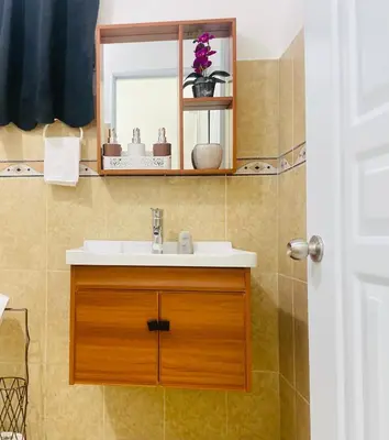a bathroom with a sink and a mirror at Centrally located Comfortable Apartment in Bonao