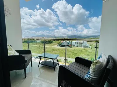 a living room with a large window with a view at Tranquilo y acogedor in Santiago de los Caballeros