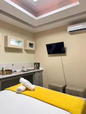 a room with a bed with a yellow blanket at Habitaciónes suite 10 min del Monumento & Agora Mall in Santiago de los Caballeros