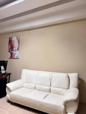a white couch sitting in a living room at Habitaciónes suite 10 min del Monumento & Agora Mall in Santiago de los Caballeros