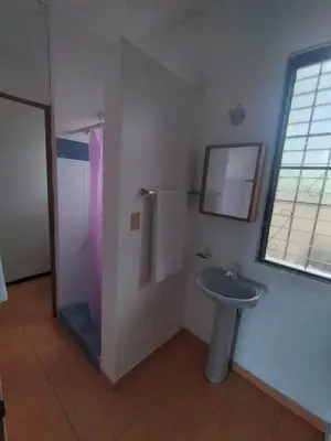 a bathroom with a sink and a mirror at Apartamentos gri gri in Río San Juan