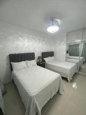 a bedroom with two beds and a chair in it at Byk in Nagua