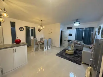 a kitchen and living room with a couch and a table at Byk in Nagua