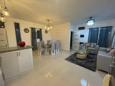 a kitchen and living room with a couch and a table at Byk in Nagua