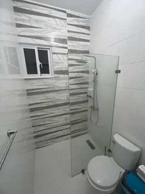 a bathroom with a toilet and a glass shower at Byk in Nagua