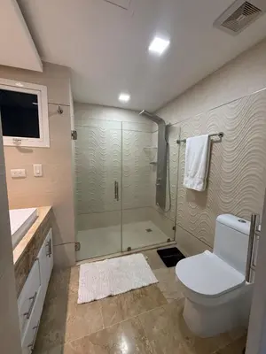 a bathroom with a shower and a toilet and a sink at Luxury 3 Rooms Apartment in SDO with Carribean Sea View in Santo Domingo