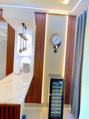 a kitchen with a counter and a clock on the wall at Skyline Stays in La Viva
