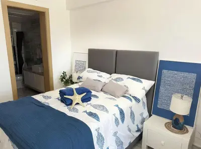 a blue and white bed with a starfish on it at Seawinds Beachfront -Top Floor Less Mosquitos -Full Security in Cabarete