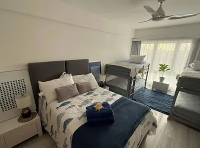 a bedroom with a bed with a stuffed animal on it at Seawinds Beachfront -Top Floor Less Mosquitos -Full Security in Cabarete