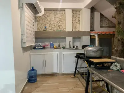 a kitchen with white cabinets and a stove in it at Villa Palmera Barahona, Dream Getaway in Santa Cruz de Barahona