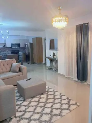 a living room with a couch and a table at The perfect destination to relax in Santiago de los Caballeros