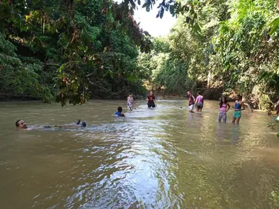 a group of people in the water in a river at Mi casita de Campo en Bayaguana in Bayaguana
