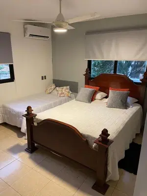 a bedroom with two beds and a window at Apartamento en el Corazón de Las Terrenas in Las Terrenas