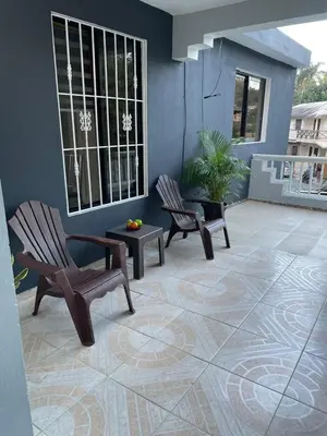 a patio with two chairs and a table at Apartamento en el Corazón de Las Terrenas in Las Terrenas