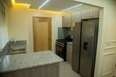a kitchen with a stainless steel refrigerator and a sink at Casa Rosario in La Grúa