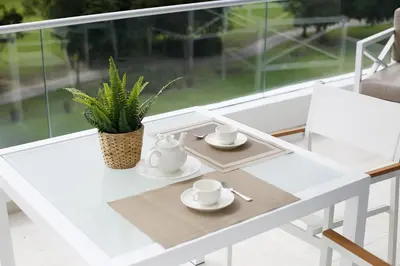 a white table with cups and saucers on it at 1BRM Infinity Homes Punta Cana in Punta Cana