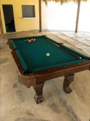 a green pool table with a ball on it at Villa María 2 in Bonao