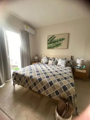 a bedroom with a large bed and a window at Apartamento Vacacional Coral Azul - SBH in Bayahibe