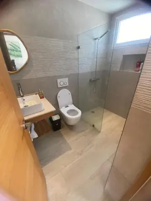 a bathroom with a toilet and a sink and a shower at Apartamento Vacacional Coral Azul - SBH in Bayahibe