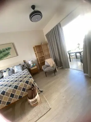 a bedroom with a bed and a chair in it at Apartamento Vacacional Coral Azul - SBH in Bayahibe