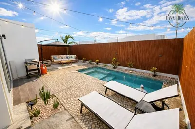 a backyard with a swimming pool and a fence at Casaè Rojas Presents Golden Oasis in Punta Cana