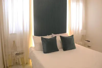 a bedroom with a bed with two pillows on it at Casaè Rojas Presents Golden Oasis in Punta Cana