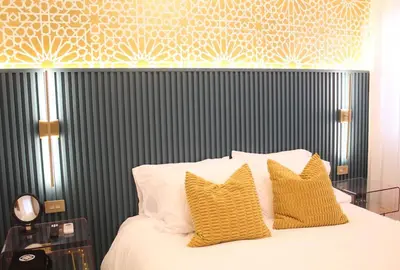 a bedroom with a bed with yellow pillows at Casaè Rojas Presents Golden Oasis in Punta Cana