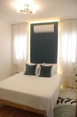 a bedroom with a bed with white sheets and pillows at Casaè Rojas Presents Golden Oasis in Punta Cana
