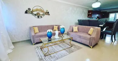 a living room with two couches and a table at Apartamento en Santo Domingo in Los Mameyes