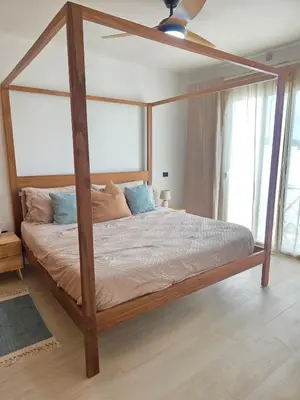 a bedroom with a wooden canopy bed in a room at Estrella Garden Shaula 104 New Modern Apartment in La Laguna