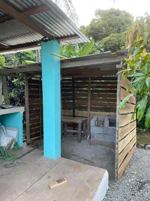 a wooden pergola with a bench and a table at Casita de Campo VIVE in Pedro Brand